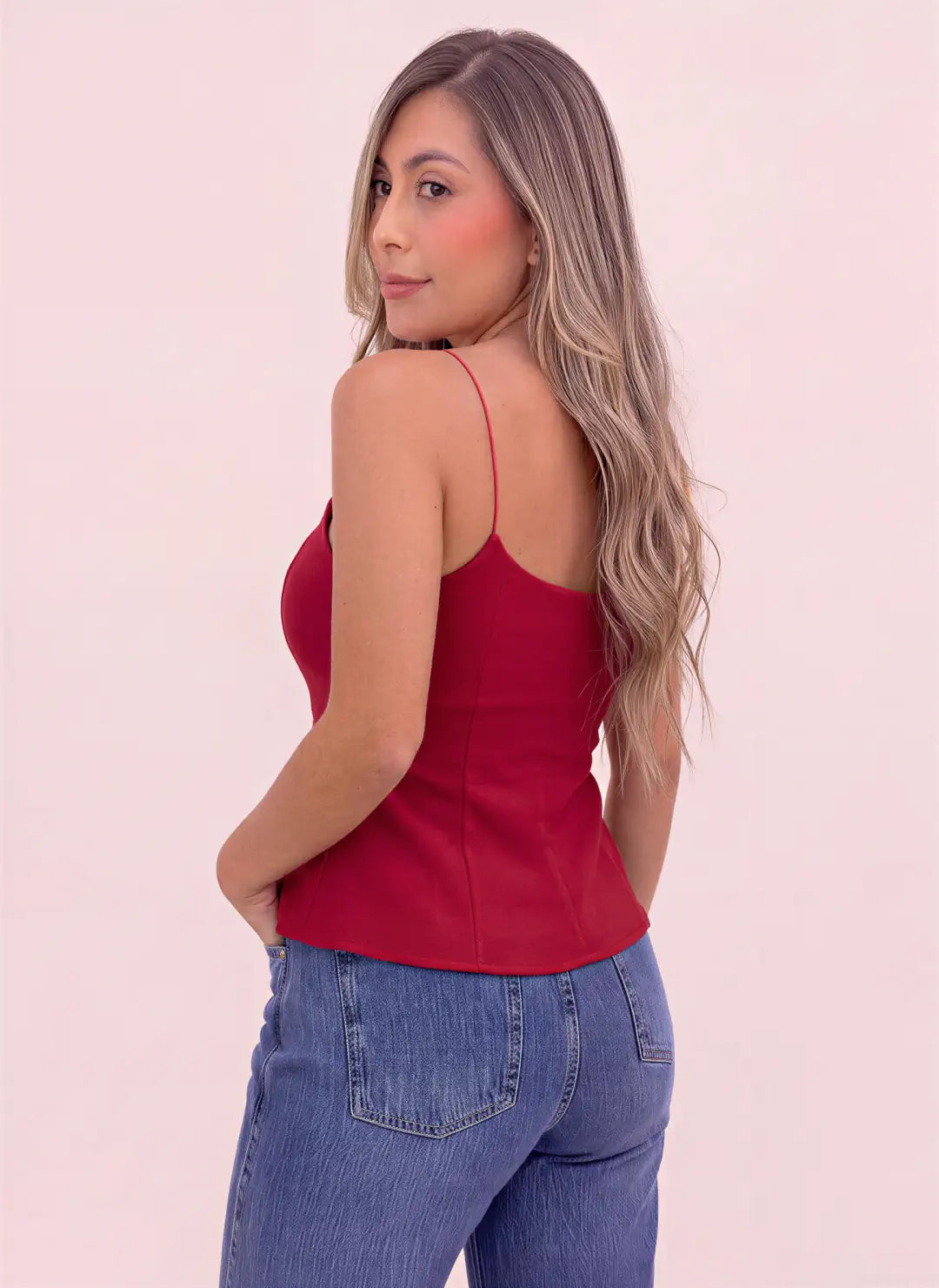 Vista posterior de blusa roja de tirantes delgados, espalda descubierta con escote redondeado y costuras verticales, de Coral.